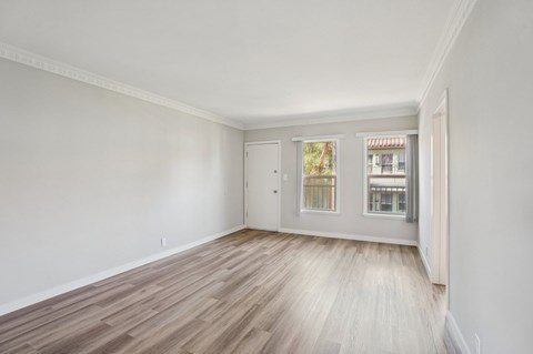 A room with a wooden floor and white walls.
