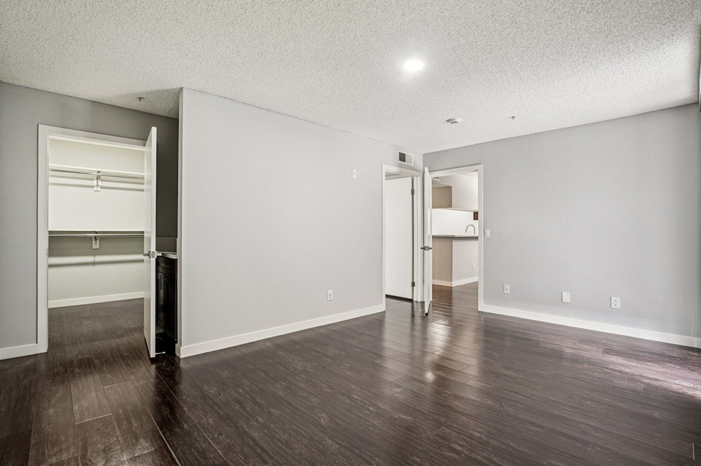 A room with a wooden floor and white walls.