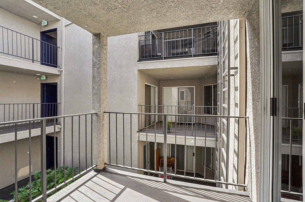 A balcony of a building with a metal railing.