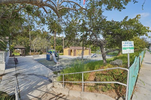 A sign in front of a playground says "BOSSES PARK EXPRESS".