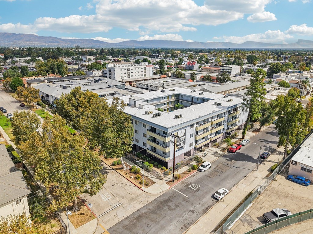 A large white building with a parking lot in front of it.