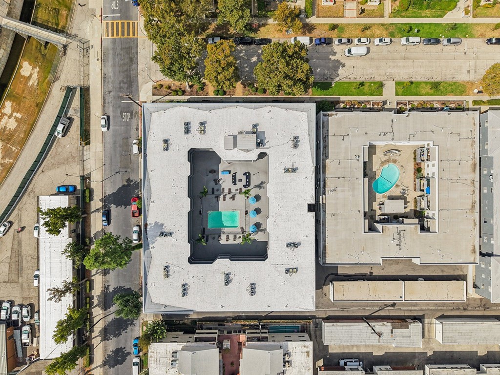 A large white building with a pool in the middle.