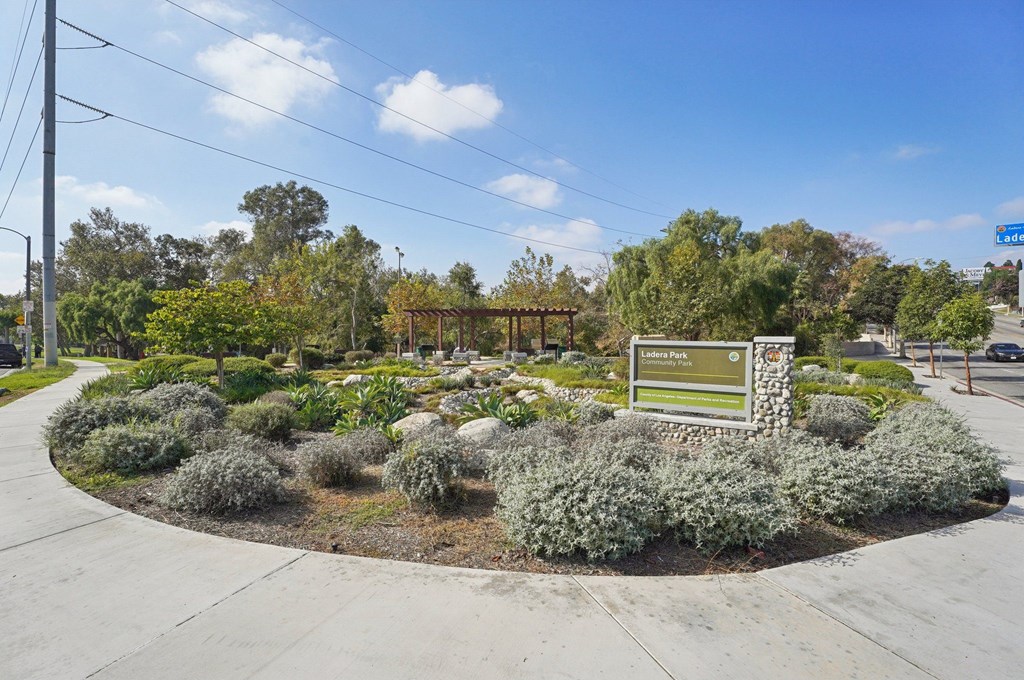 A landscaped area with a sign that reads "Lake Pointe".
