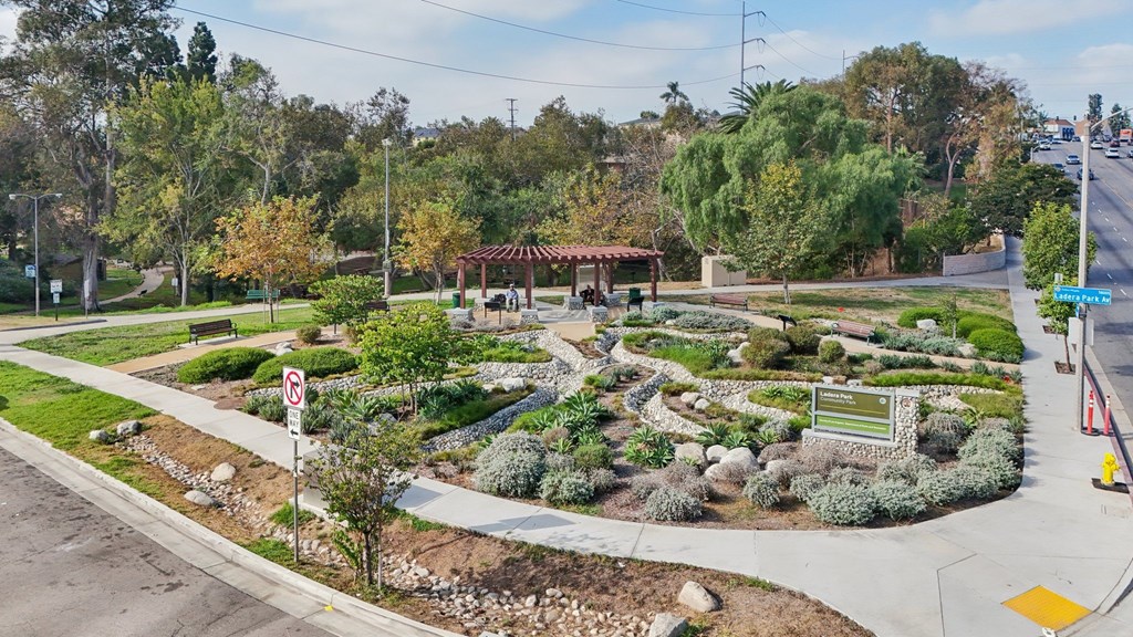 A landscaped garden area with a no parking sign in the foreground.