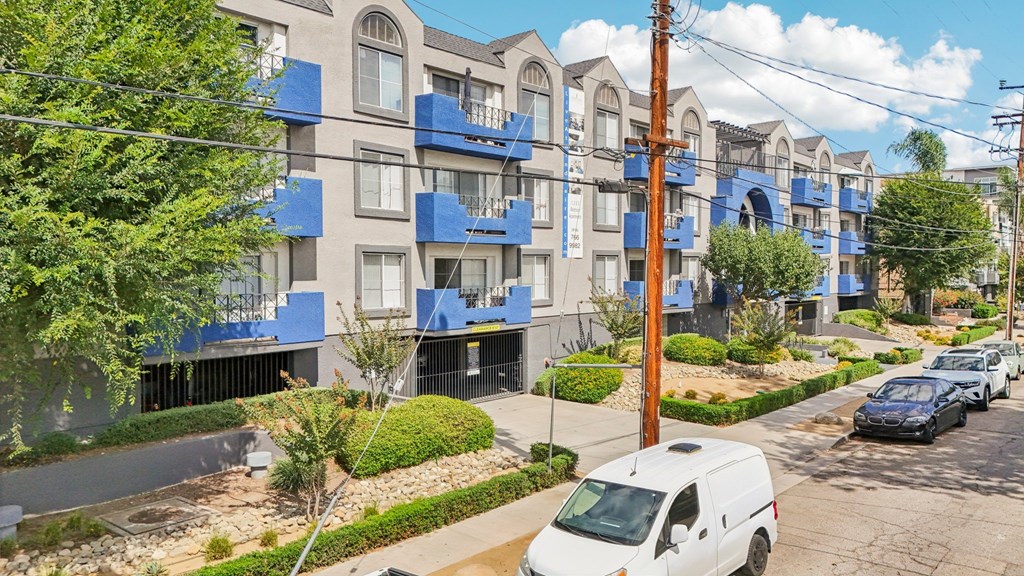A white van is parked on the side of a street.