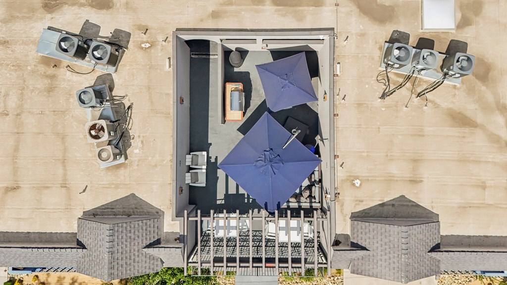 A blue umbrella is opened in a doorway.
