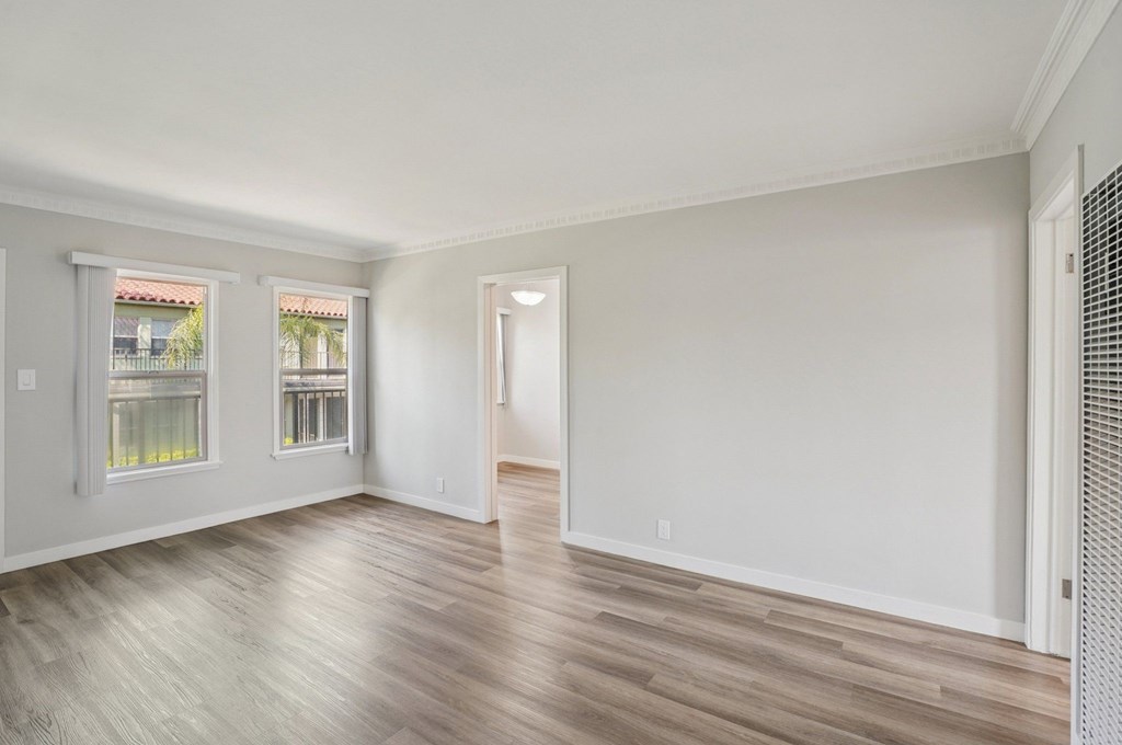 A room with wooden floors and white walls.