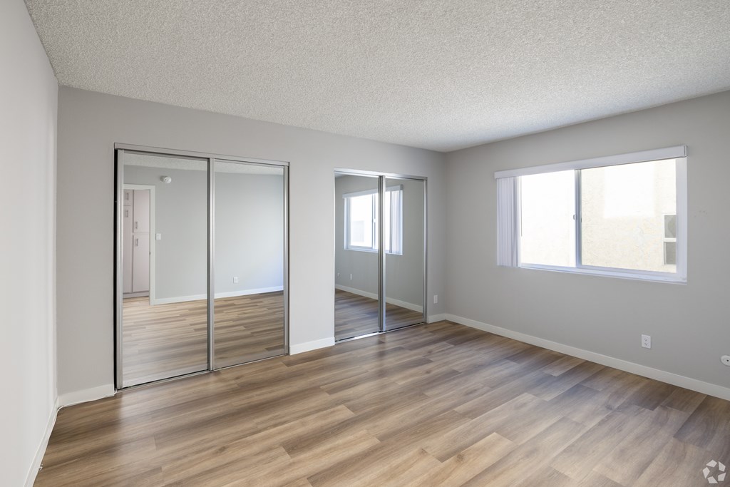 A room with wooden floors and white walls.