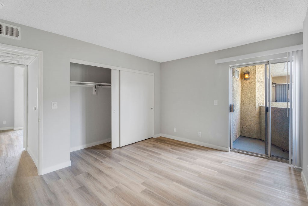 A room with a wooden floor and white walls.
