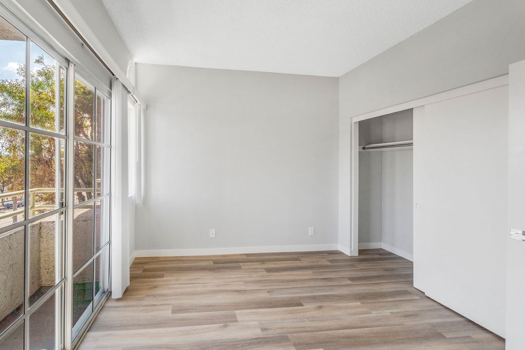 A room with a wooden floor and white walls.