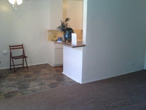 a living room with a counter and a chair