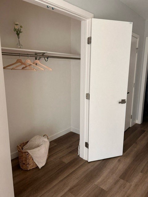 a room with a closet and a basket on the floor