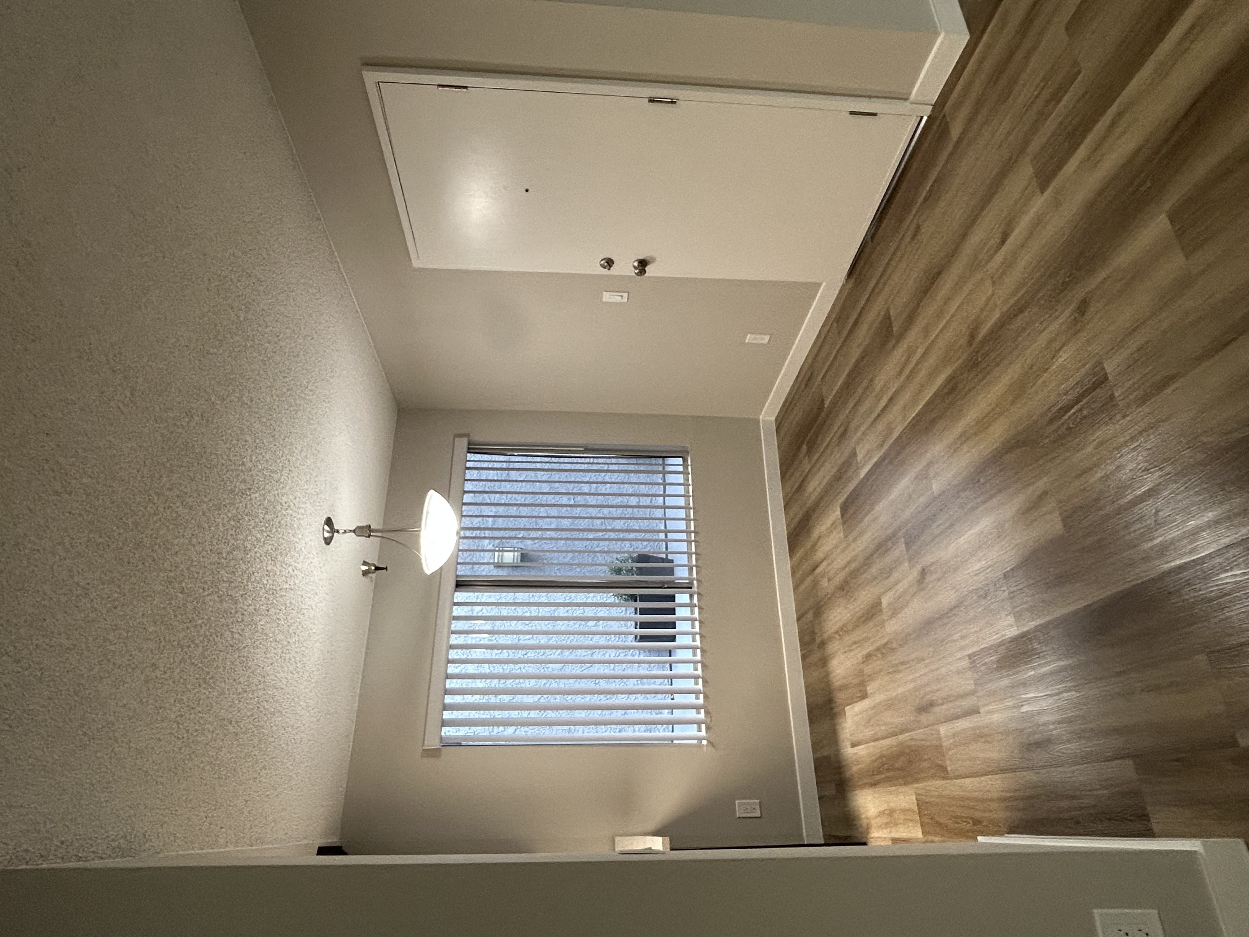 a view of a bathroom with a window and a mirror