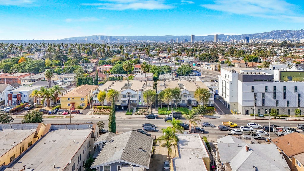 A cityscape with buildings and cars on the streets.
