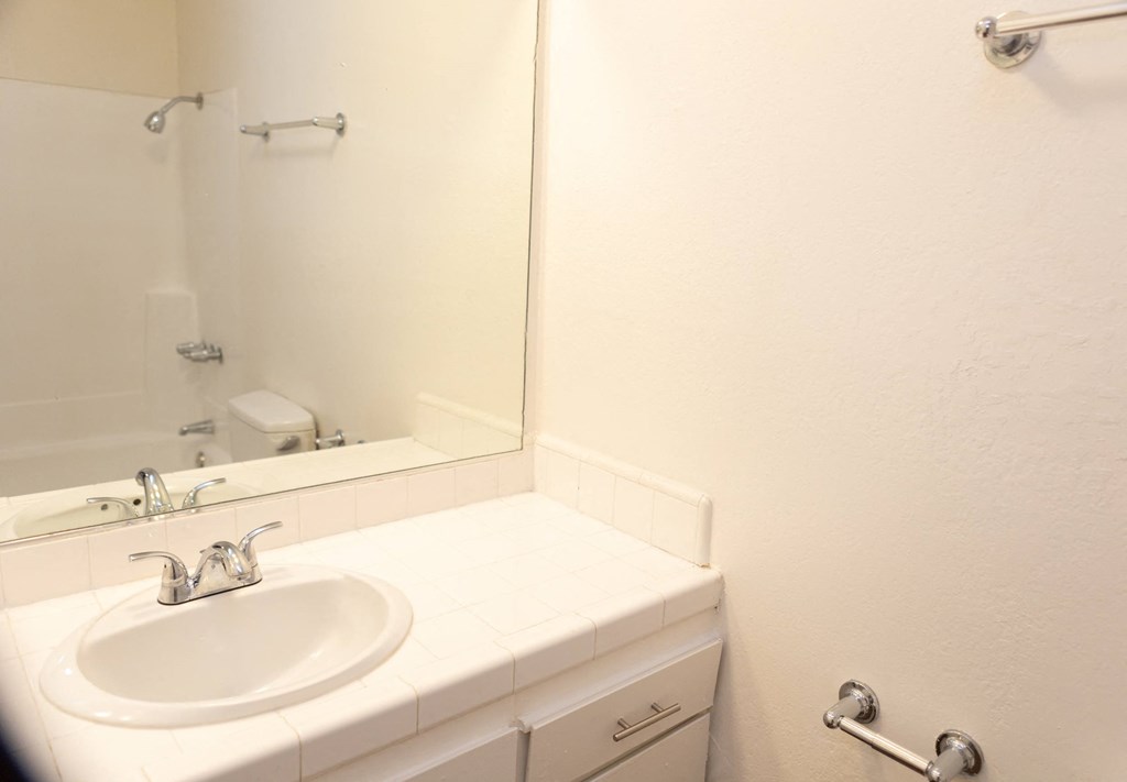 Arms bathroom. a white bathroom with a sink and a mirror