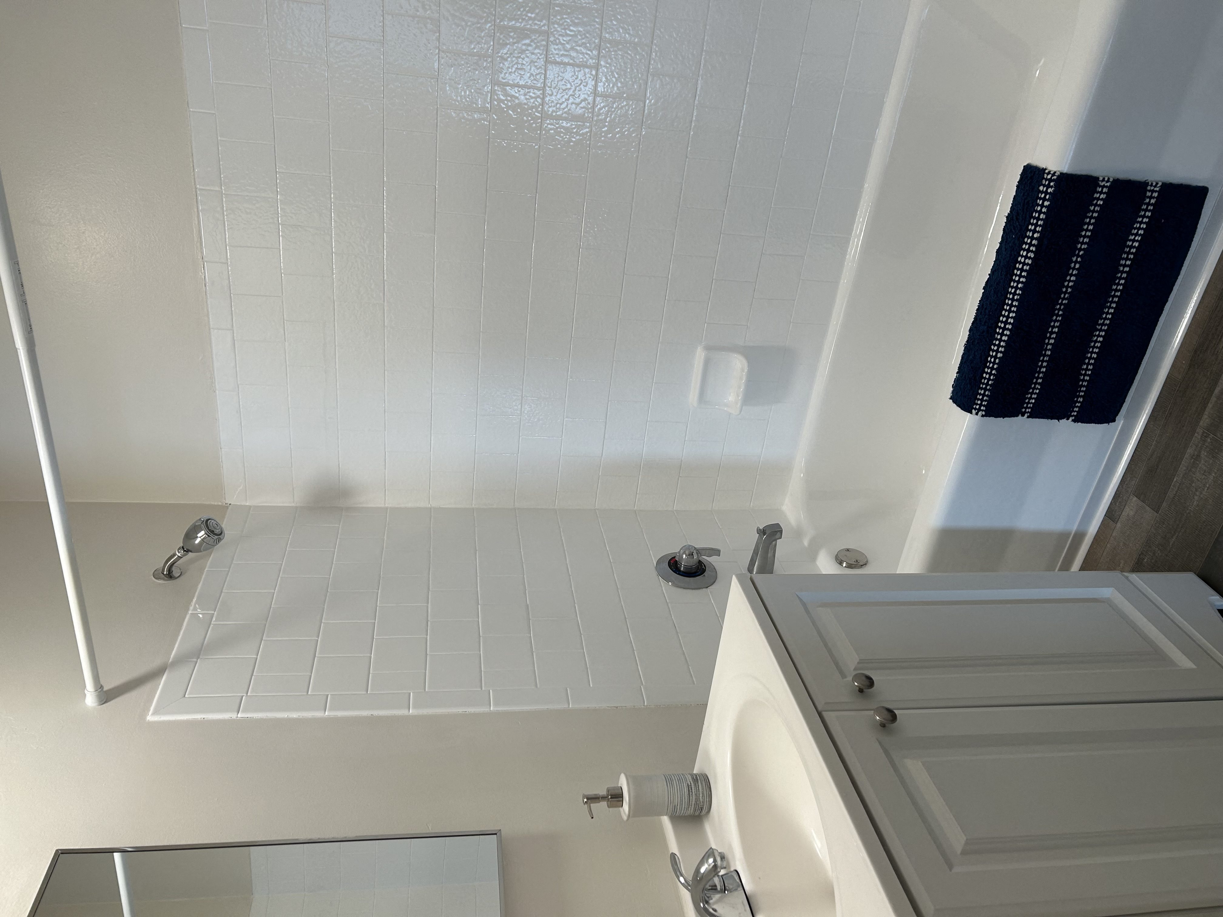 a white bathroom with a shower and a toilet