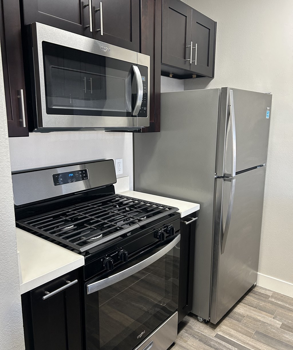 a kitchen with stainless steel appliances and a stainless steel refrigerator