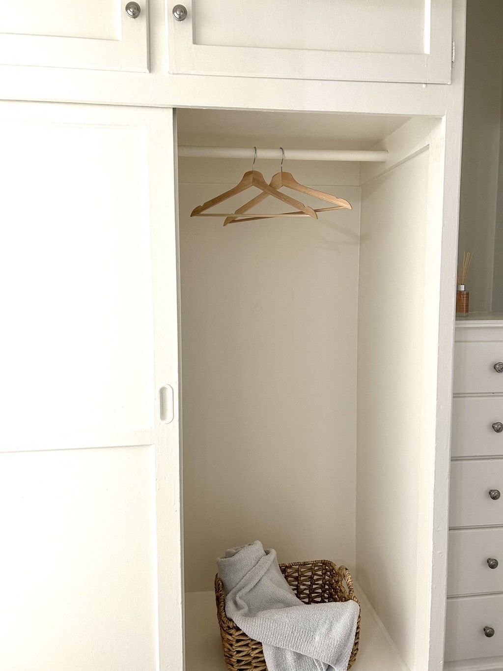 a closet with a basket of towels in it