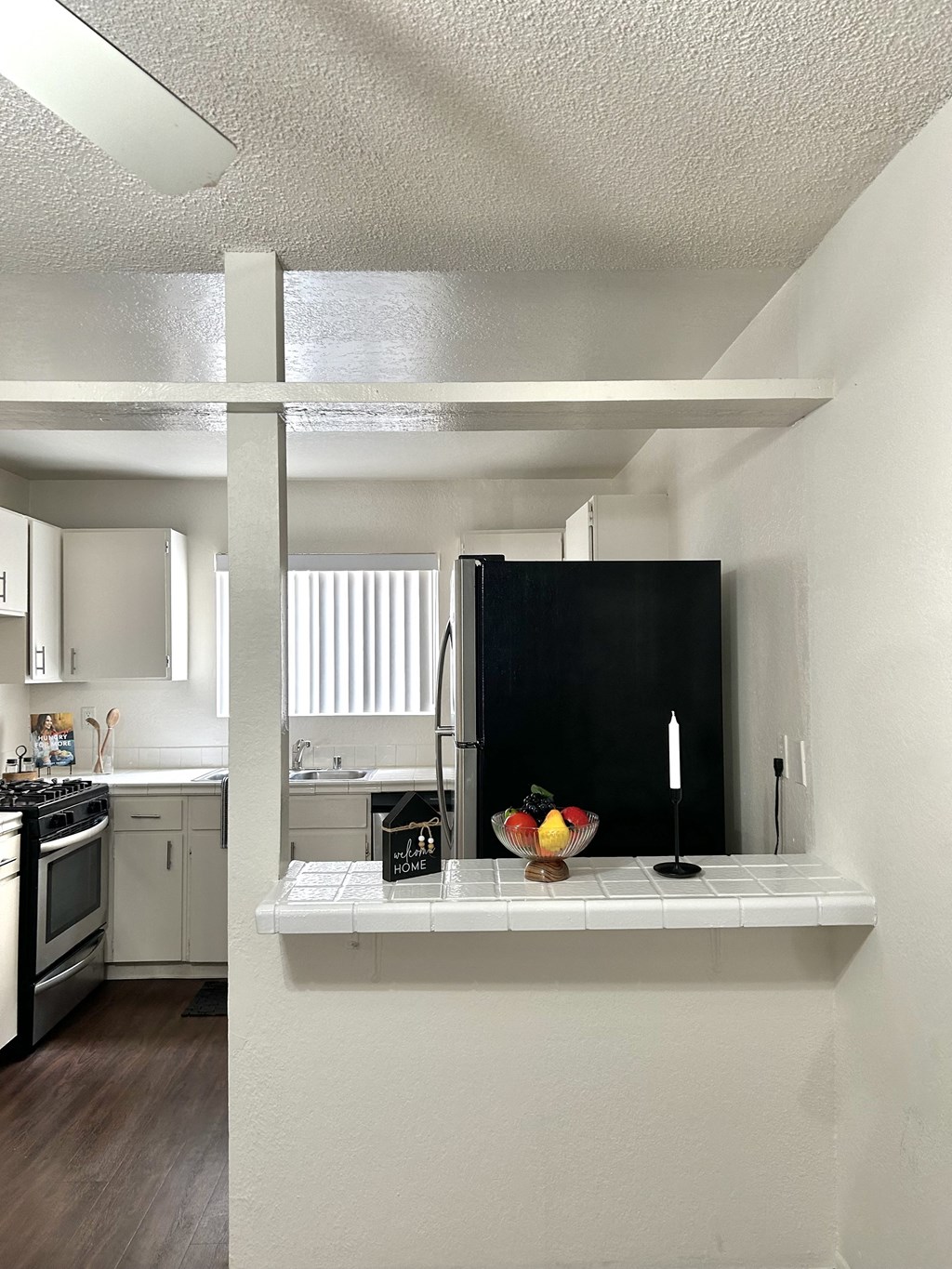 a kitchen with a counter top and a refrigerator
