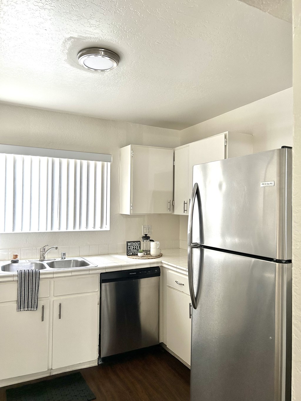 a kitchen with stainless steel appliances and white cabinets
