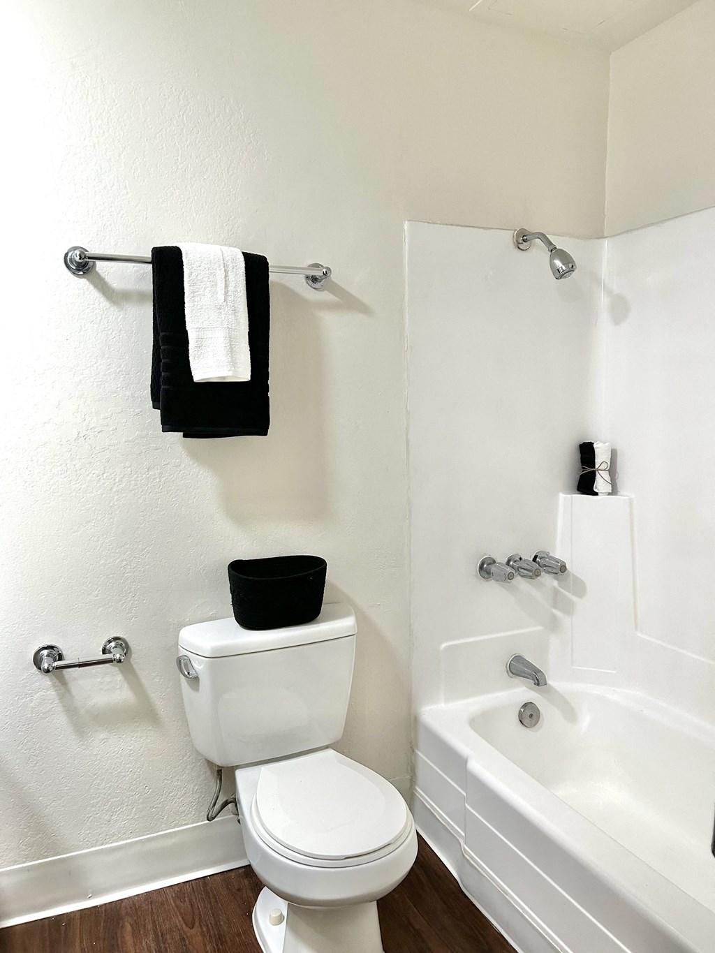 a bathroom with a toilet and a tub and a sink