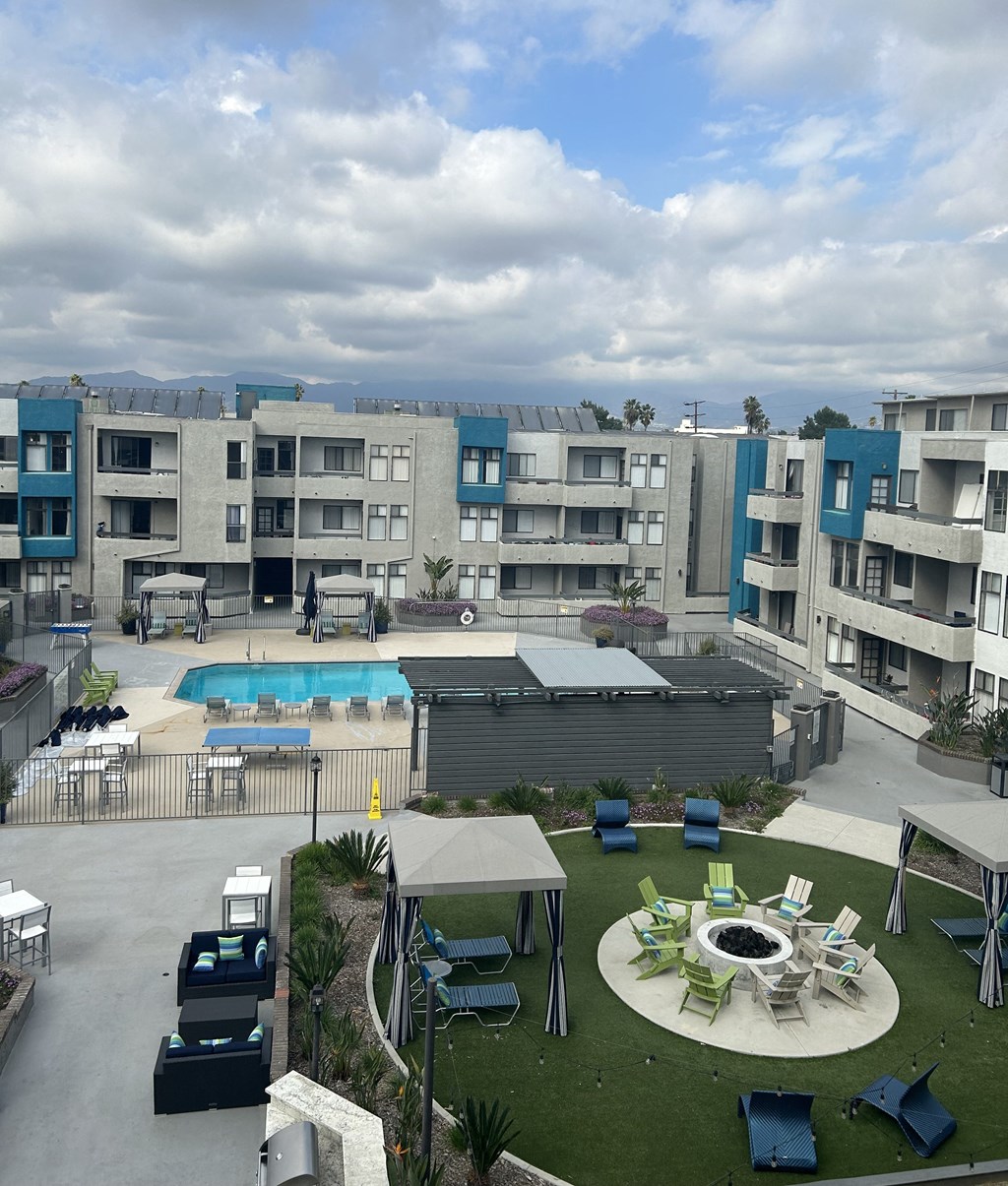 a view of the courtyard of a apartment building with a pool
