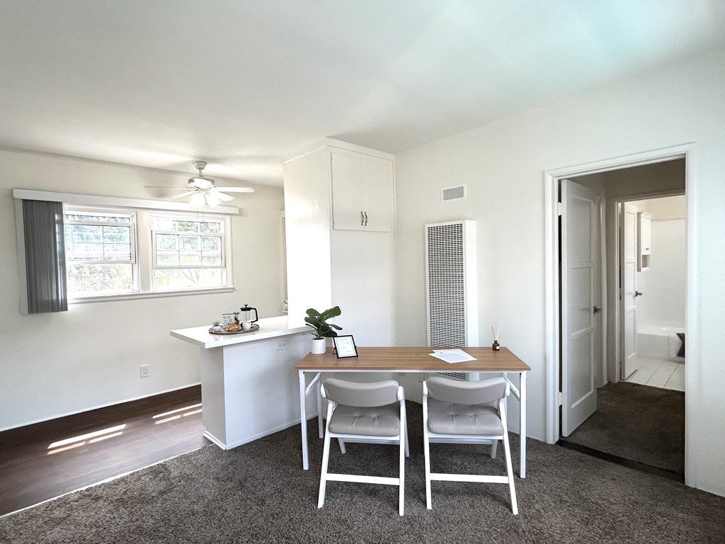 A white room with a table and chairs.