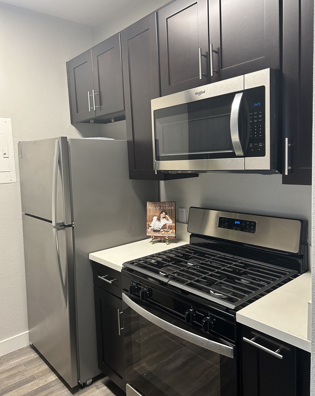 a kitchen with stainless steel appliances and black and white cabinets