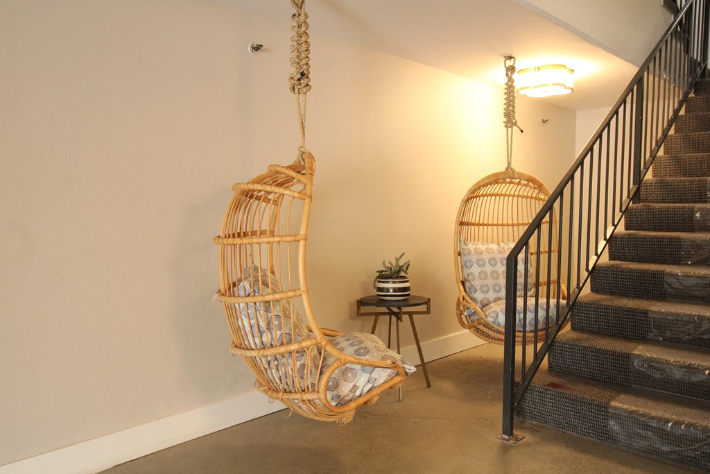 a hammock swing in a living room next to a staircase