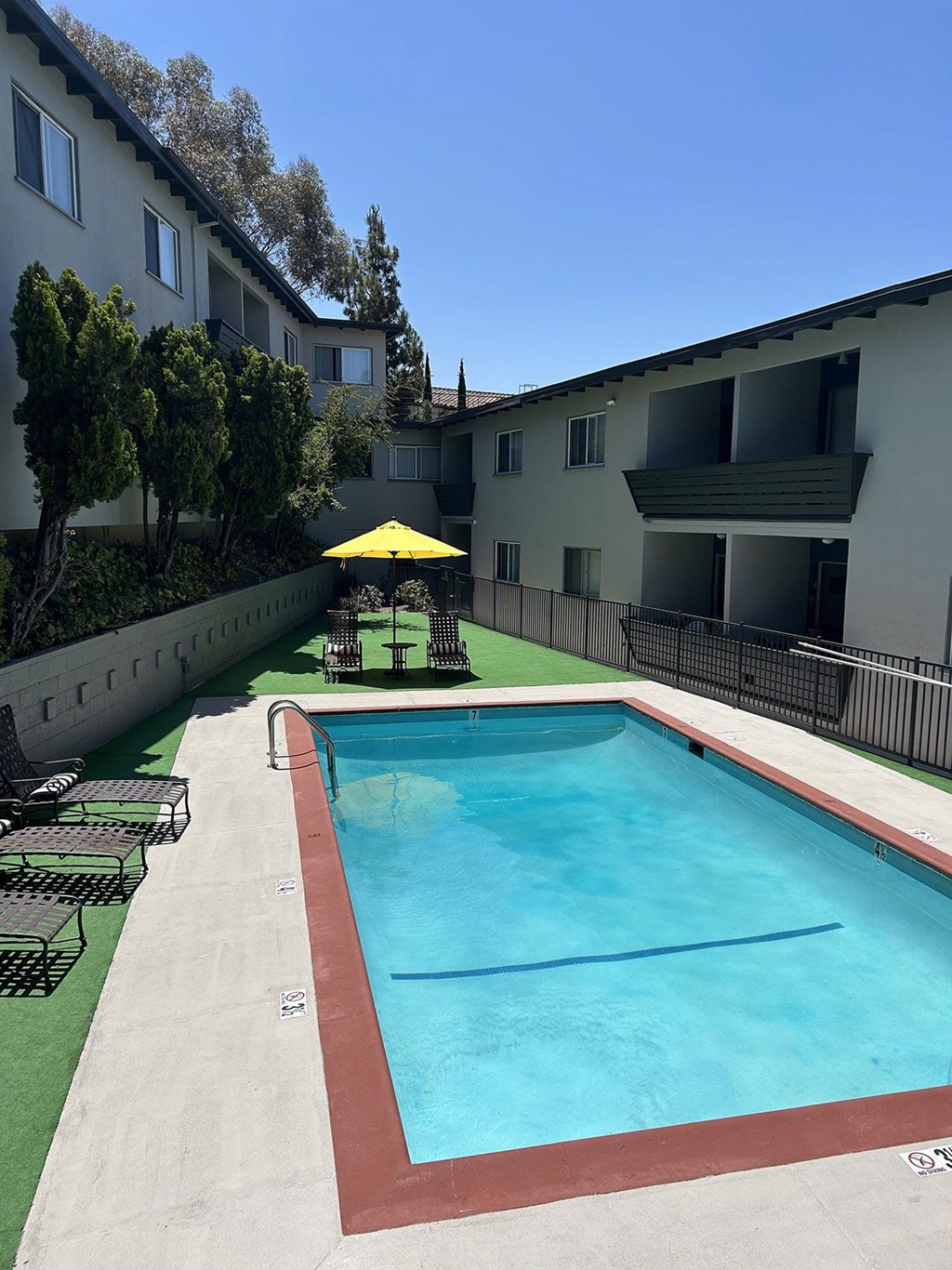 A swimming pool is located on the side of a building.