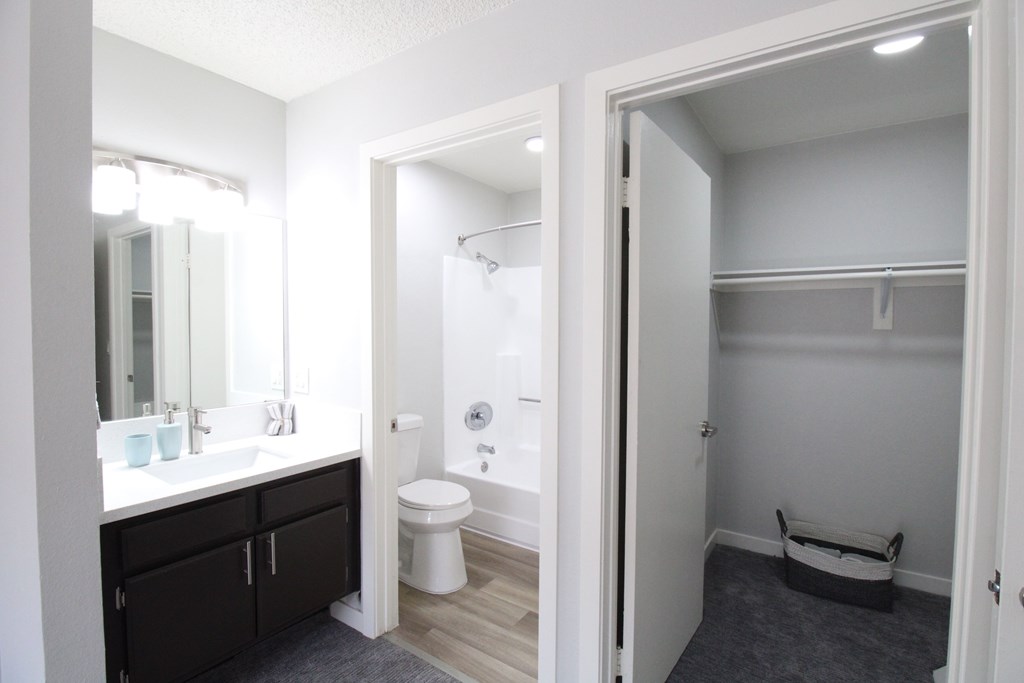A bathroom with a toilet, sink, and a walk-in shower.