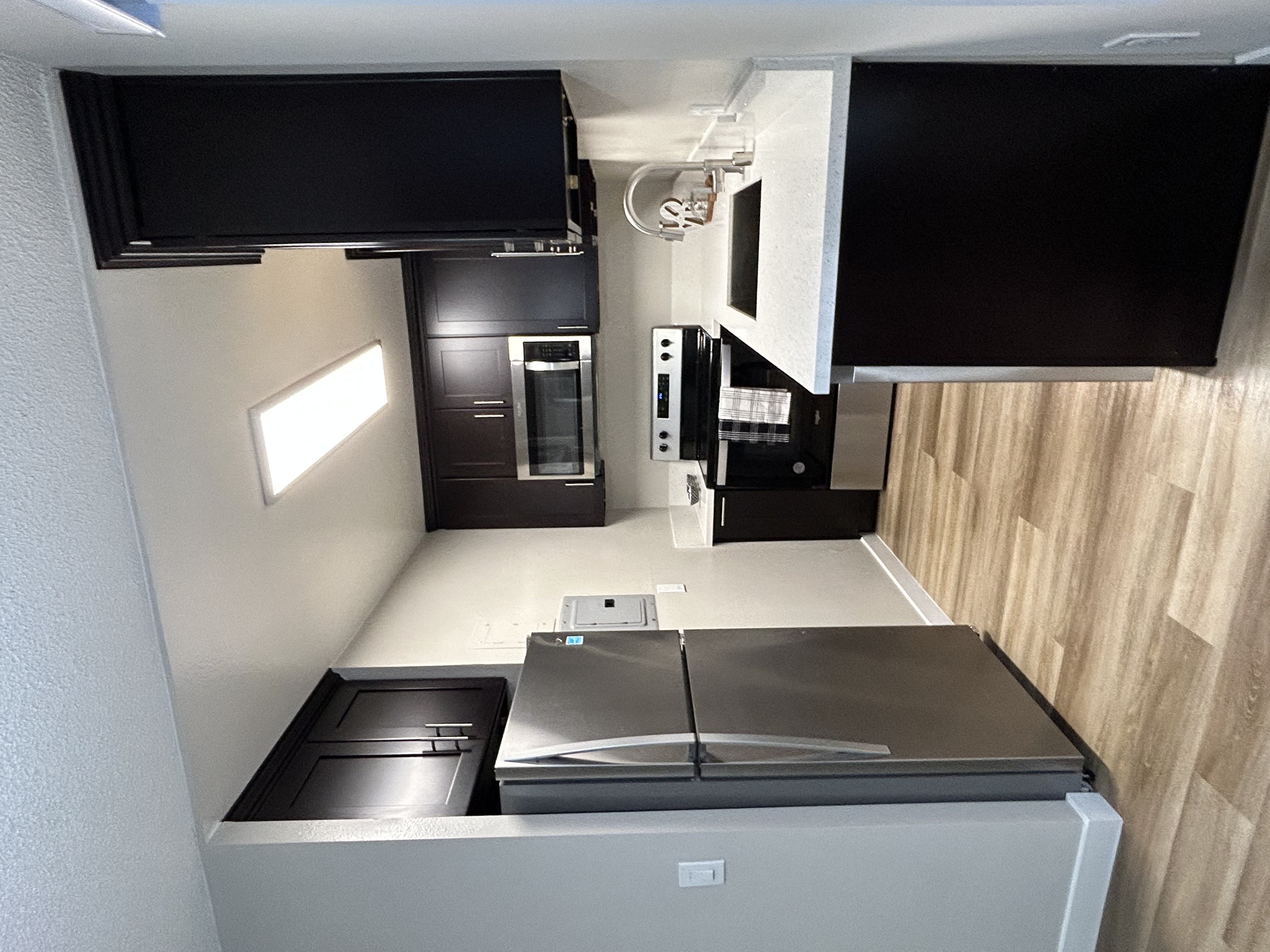 a kitchen with a counter top and a stove and a microwave