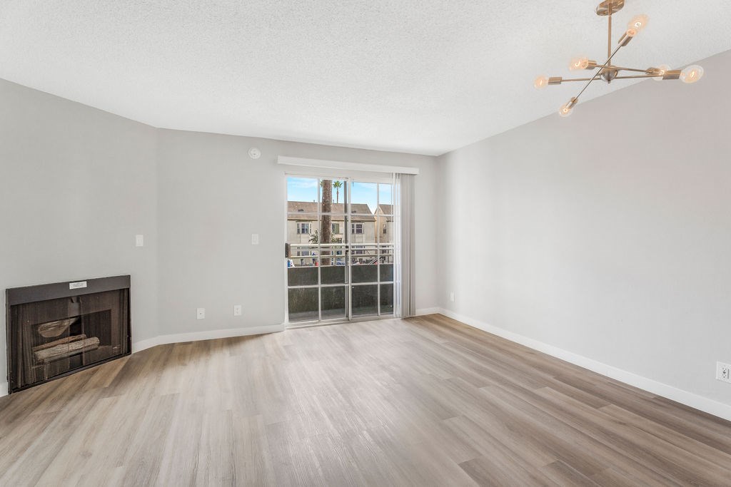 A room with a fireplace and a wooden floor.