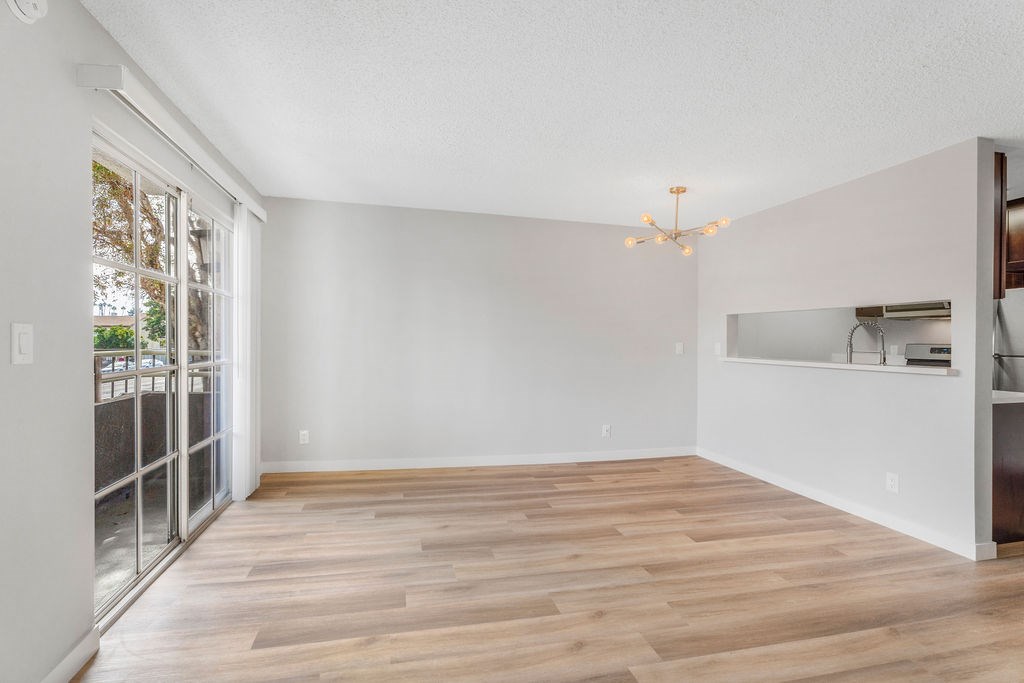 A room with wooden floors and a chandelier.