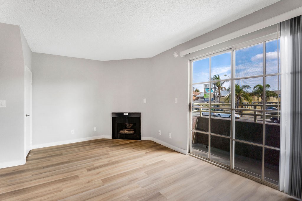 A room with a fireplace and a view of the outside.
