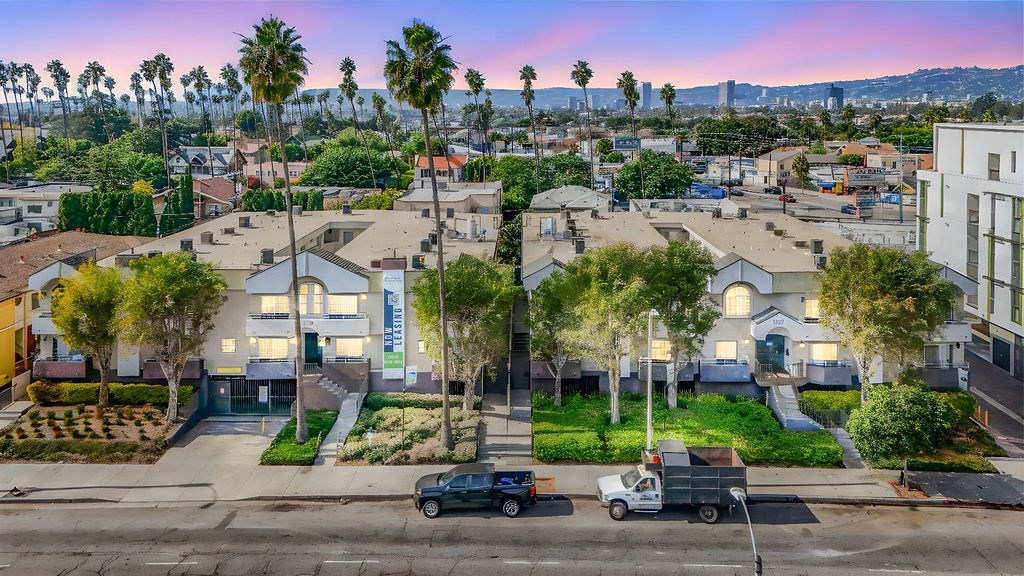 A residential area with houses and parked cars.