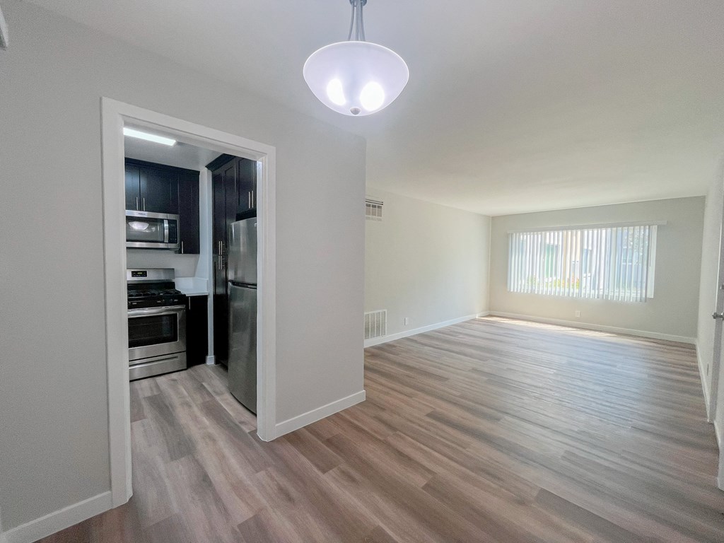 an empty living room and kitchen in a new home