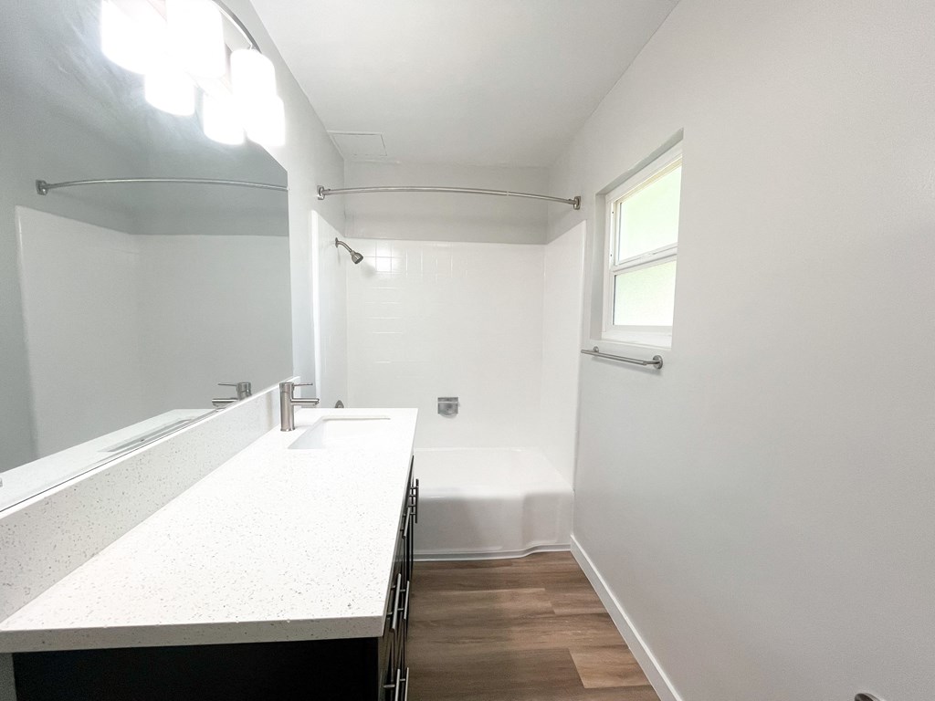 an empty bathroom with a sink and a mirror
