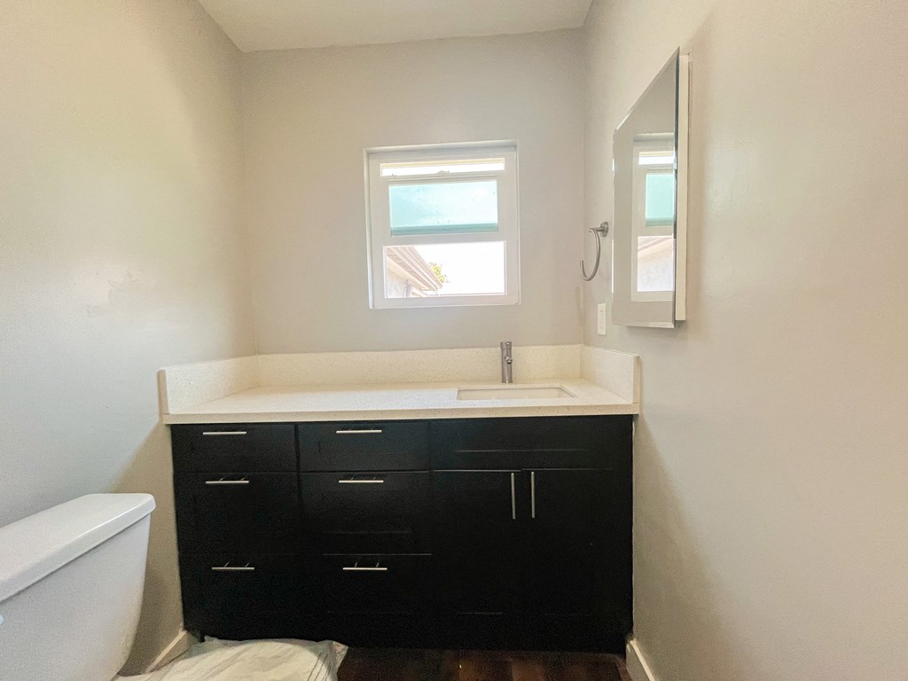 an empty bathroom with a sink and a window