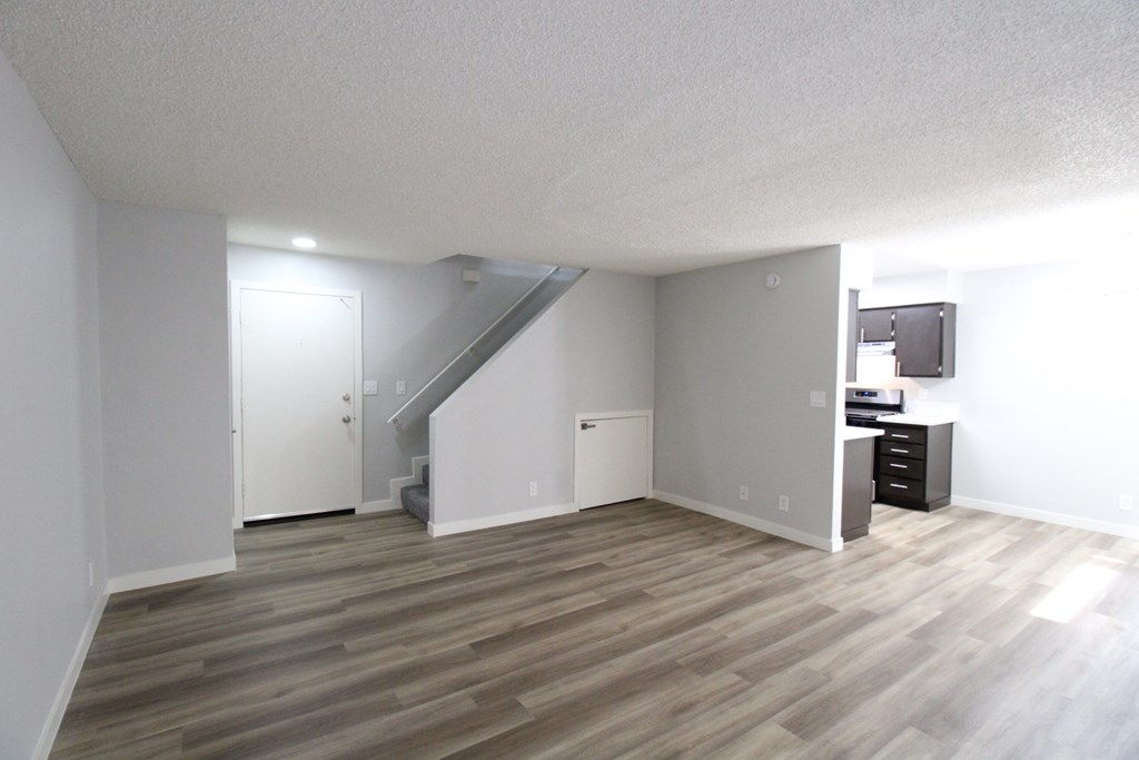 A room with a staircase and a cabinet.