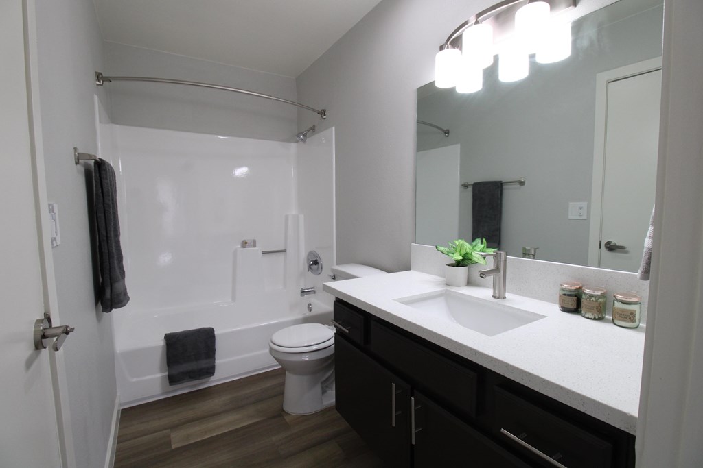 A bathroom with a white sink and a white toilet.