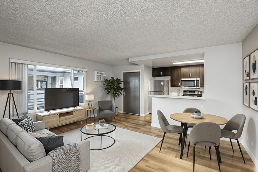 A modern living room with a grey sofa, a black coffee table, and a television.