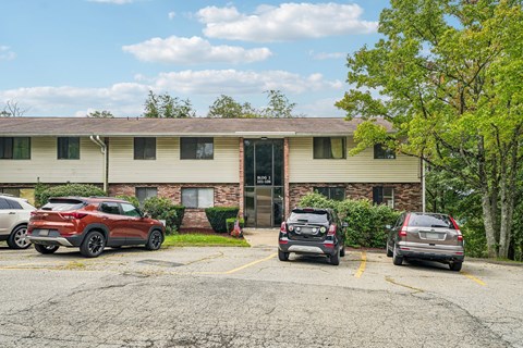 A parking lot with cars and a building in the background.