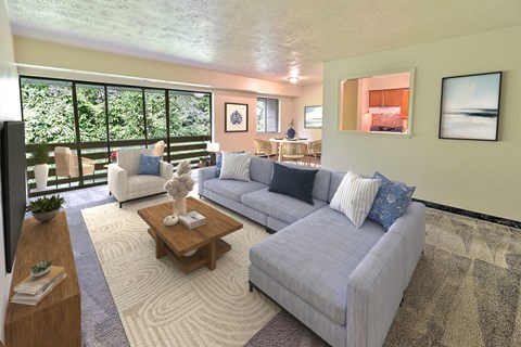 A living room with a grey couch and a coffee table.