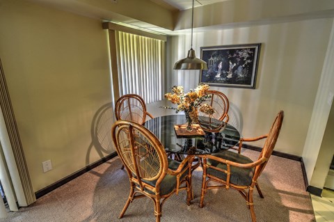 Model Apartment: A dining room with a round table and chairs.