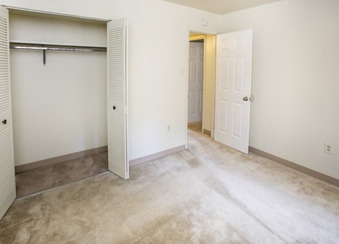 A room with a white door and a white wall.