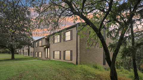 A building with a grassy area in front of it.