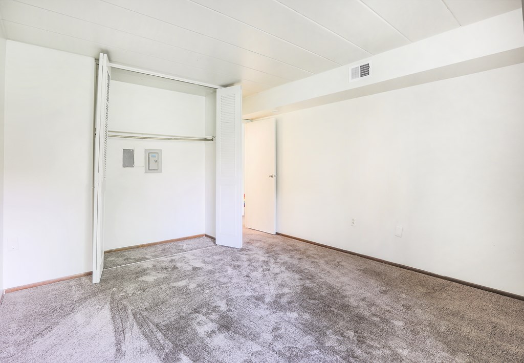 A room with a carpeted floor and white walls.