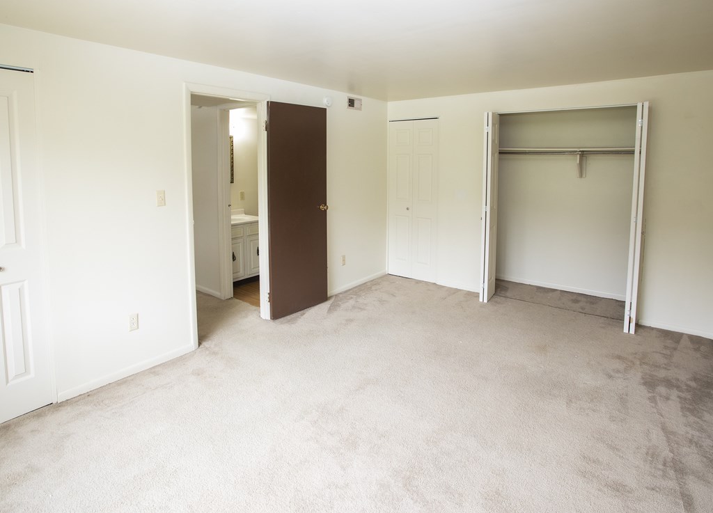 A room with a carpeted floor and white walls.