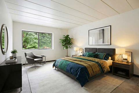 A bedroom with a large bed and a chair.
